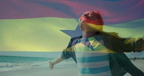 Woman celebrating freedom on tropical beach with ghana flag overlay, joyful summer moment