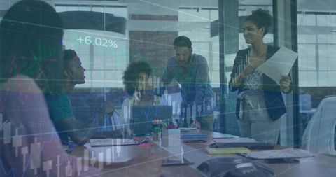 Diverse business team collaborating with financial data concept overlay