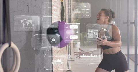 Female athlete training with rebound ball and augmented reality fitness HUD in urban gym