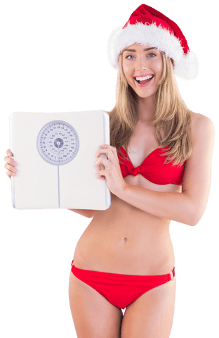 Caucasian woman in santa hat holding scales transparent background