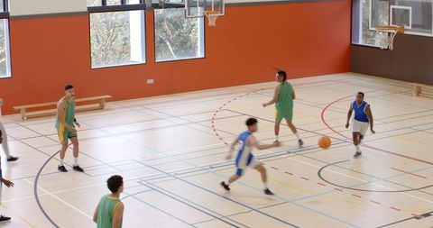 Basketball Players Competing Energetically in Gymnasium