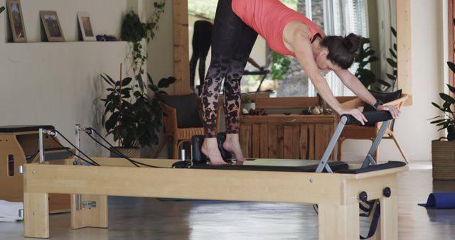 Senior Woman Practicing Pilates at Home Using Reformer - Download Free Stock Images Pikwizard.com