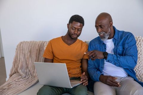 Father and Son Using Laptop for Bonding Experience