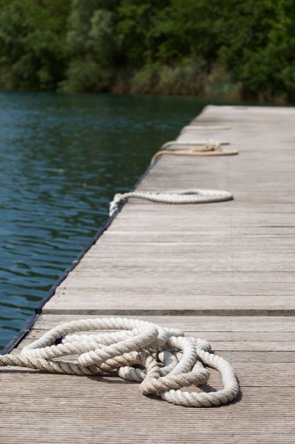 Coiled Rope on Wooden Dock by Tranquil Lake - Download Free Stock Images Pikwizard.com