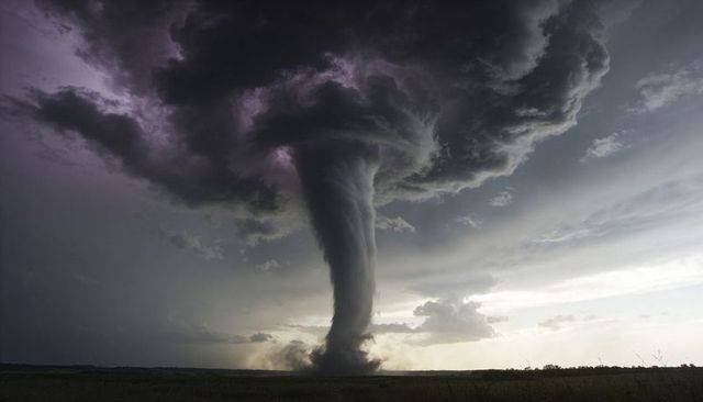 Towering Tornado Funnel Descending from Supercell over Flat Plains with Dust Plume