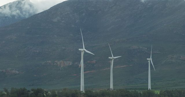 General view of wind turbines in countryside landscape with mountains. environment, sustainability, ecology, renewable energy, global warming and climate change awareness.