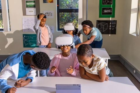 Elementary students using vr headsets for immersive stem learning in diverse classroom