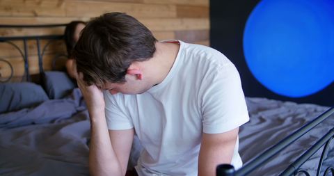 Couple Experiencing Conflict in Bedroom Environment
