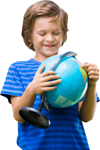 Young boy smiling while holding globe on white background