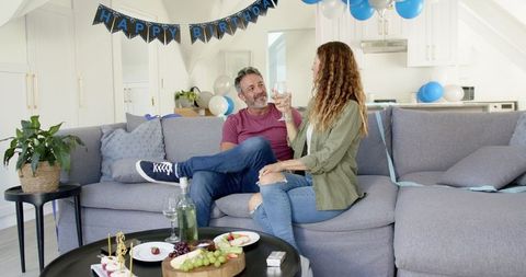 Mature Couple Celebrating Birthday with Wine at Home