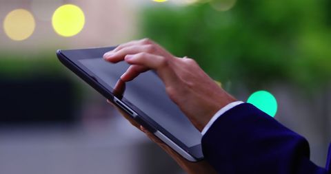 Businesswoman's Hand Using Tablet on City Street - Download Free Stock Images Pikwizard.com