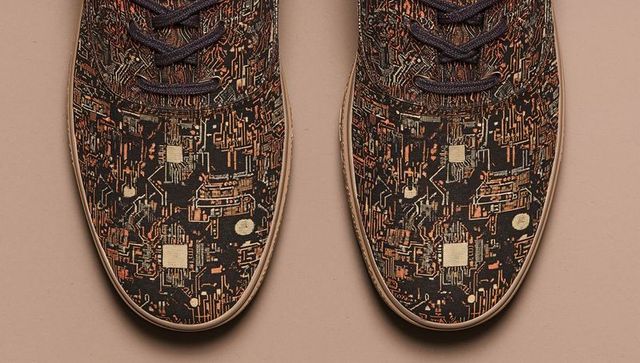 Displaying pair of low-top sneakers with circuit-board pattern on beige backdrop