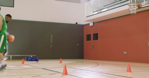 Diverse basketball team dribbling cone drill practicing midrange shooting and layups