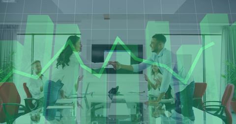 Business colleagues shaking hands with financial data overlay