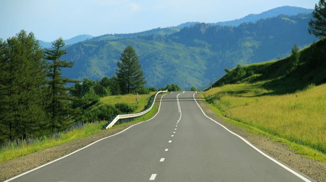 Empty Road Winding Through Lush Green Mountains on Sunny Day - Download Free Stock Photos Pikwizard.com