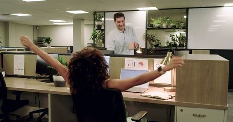Woman stretching at work in modern office setting