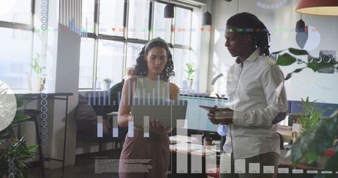 Business Team Analyzing Digital Financial Graphs at Office