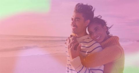 Couple Embracing on Beach at Sunset with Dreamy Glow