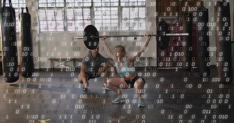 Female athlete lifting overhead barbell with coach spotting, binary code overlay