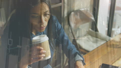 Woman Analyzing Finance on Laptop with Coffee at Cafe