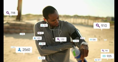 Athlete Engaged with Smart Technology While Running Outdoors