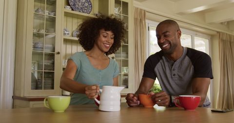 Smiling Couple Enjoying Breakfast Together in Cozy Kitchen - Download Free Stock Images Pikwizard.com