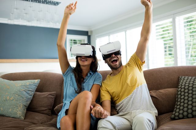 Couple using virtual reality headset in living room at home