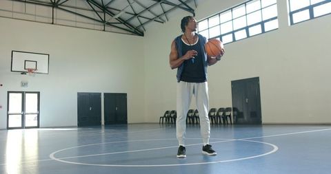 Athlete Preparing on Indoor Basketball Court in Sports Hall