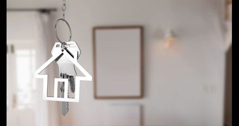 Silver House Keychain in Bright Interior Background