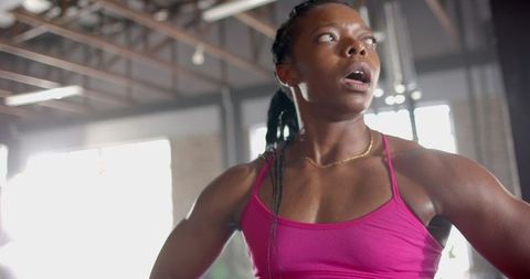 Determined woman in gym showcasing fitness enthusiasm