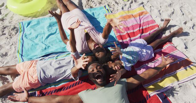 Happy Family Lying on Beach Towels Enjoying Summer Vacation - Download Free Stock Images Pikwizard.com