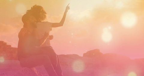 Romantic Couple Enjoying Sunset on Scenic Rocky Outcrop