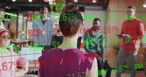 Woman presenting codes on glass board in modern office