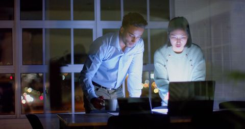 Diverse Team Collaborating on Late Night Project in Office - Download Free Stock Images Pikwizard.com