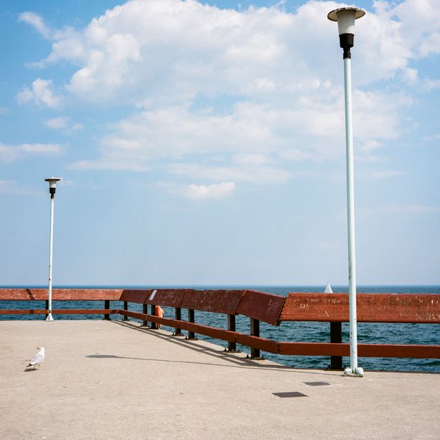 Scenic Wooden Pier Overlooking Tranquil Ocean Under Blue Sky - Download Free Stock Images Pikwizard.com