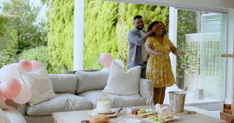 Couple Celebrating Special Moment with Cake on Patio