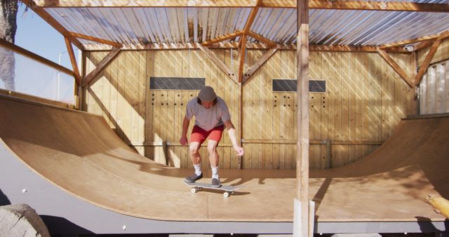 Image of caucasian male skateboarder training in skate park. Skateboarding, sport, active lifestyle and hobby concept.