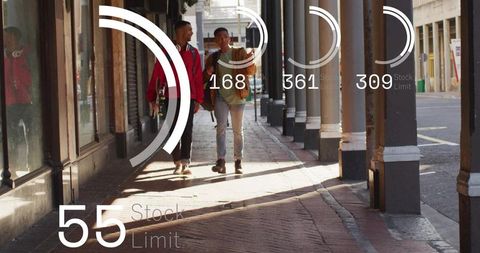 Two friends walking with skateboard along sunlit brick arcade with column shadows