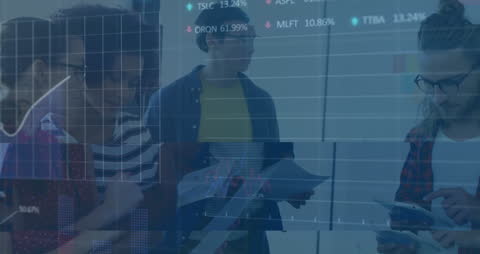 Diverse Colleagues Analyzing Stock Market Data in Office