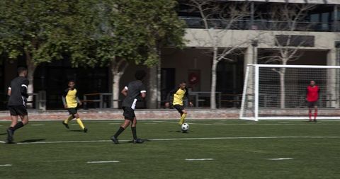 Soccer Players Competing Intently in Outdoor Match