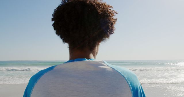 Person with Curly Hair Looking at Ocean, Tranquility at Beach - Download Free Stock Images Pikwizard.com