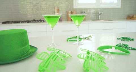 St patrick's day party featuring neon green cocktails, felt top hat, shamrock sunglasses