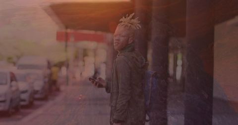 stylish urban man with mobile phone under sunset glow - Download Free Stock Images Pikwizard.com