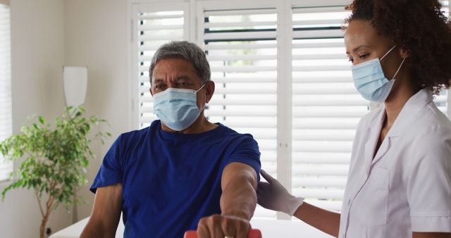 Healthcare Worker Assisting Elderly Man in Rehabilitation Center - Download Free Stock Images Pikwizard.com