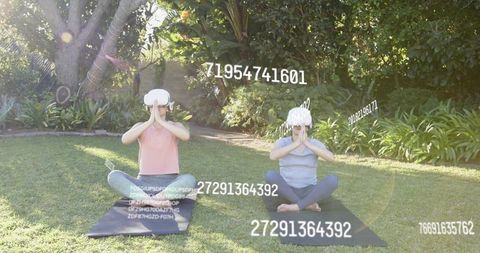 Vr-guided meditation outdoors: two women practicing mindfulness wearing vr headsets