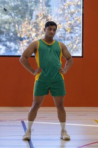 Confident Basketball Player Standing on Indoor Court