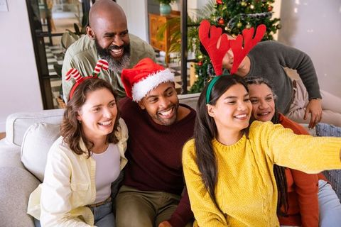 Diverse Family Celebrating Christmas and Taking Selfie in Cozy Living Room