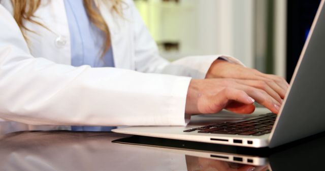 Female Doctor Typing on Laptop in Hospital - Download Free Stock Images Pikwizard.com