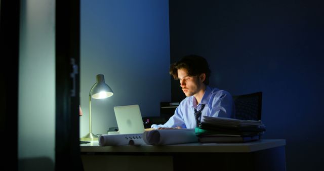 Late Night Working Professional Focused on Laptop at Desk - Download Free Stock Images Pikwizard.com