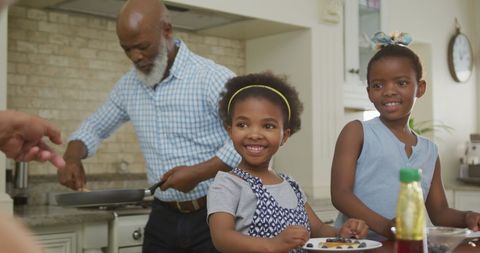 Grandfather Cooking and Playing with Granddaughters at Breakfast Time - Download Free Stock Images Pikwizard.com